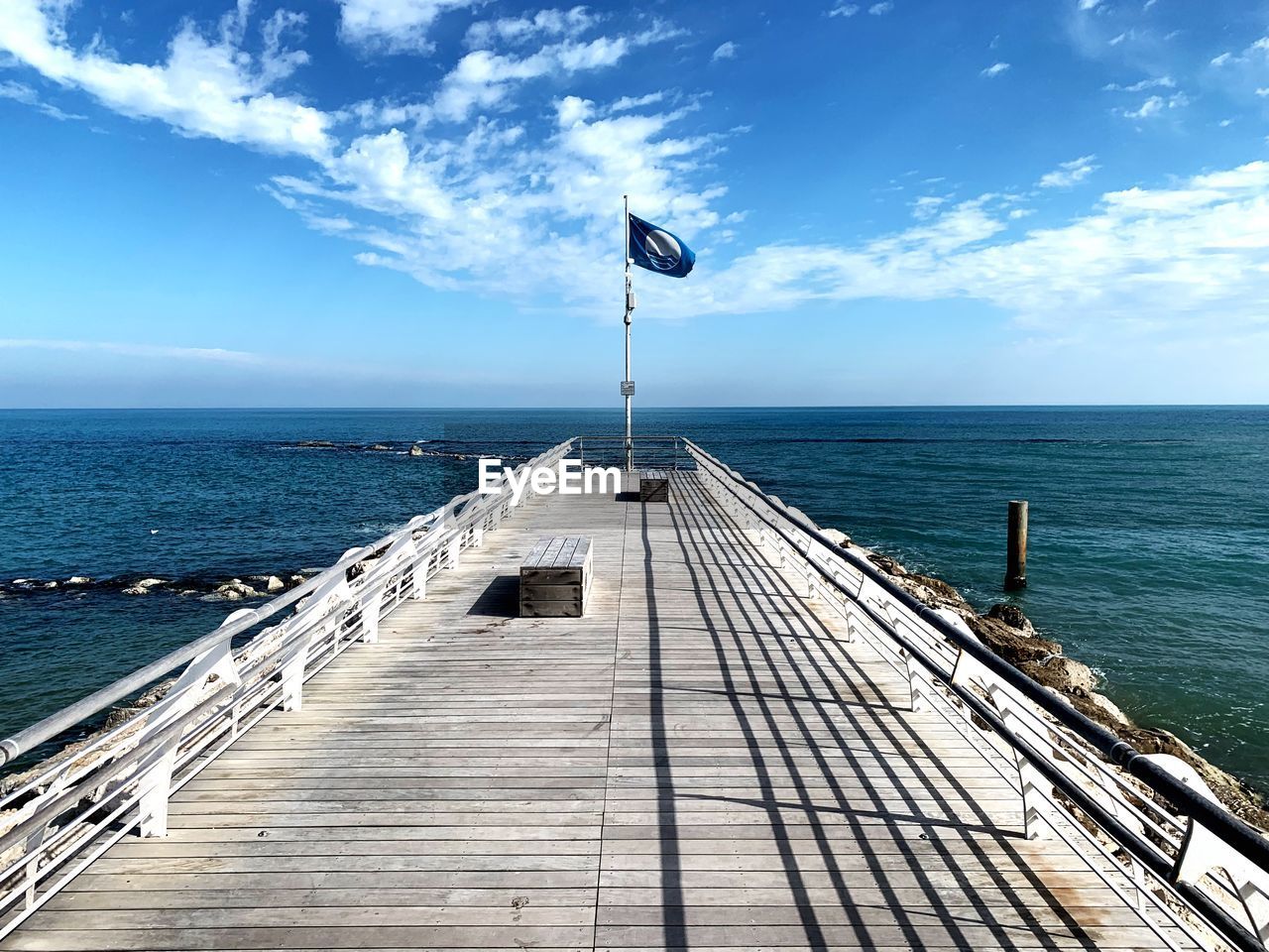 Pier over sea against sky