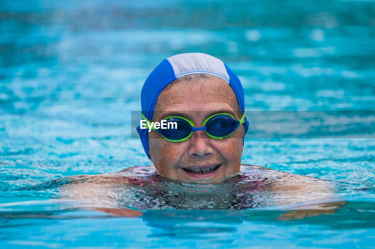 Senior woman swimming in pool