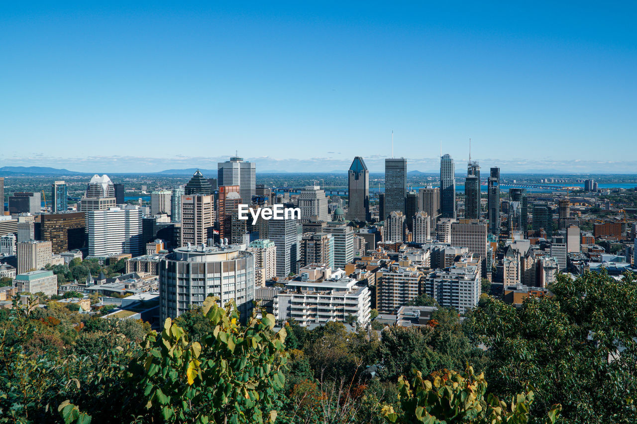 View of modern buildings against blue sky