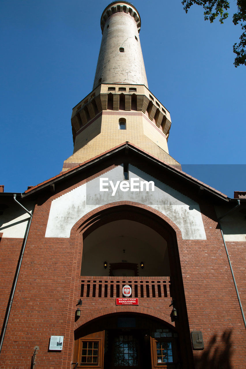 LOW ANGLE VIEW OF CHURCH AND BUILDING AGAINST SKY