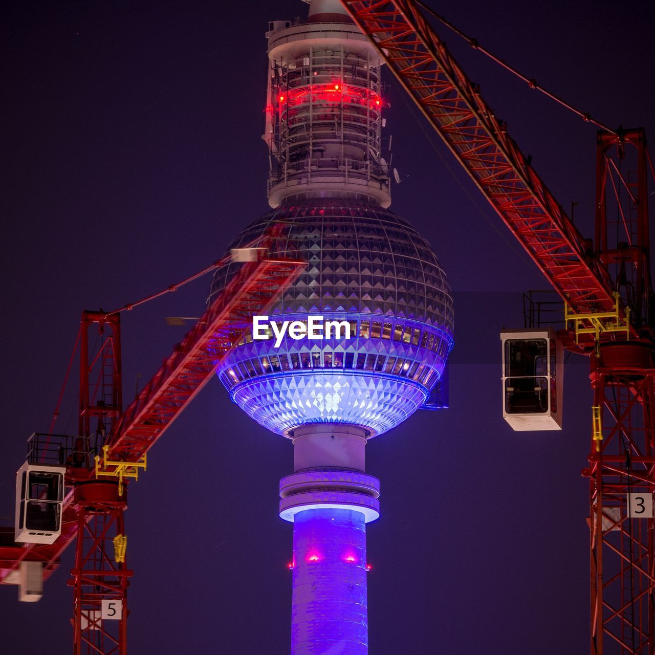 LOW ANGLE VIEW OF ILLUMINATED BUILT STRUCTURE