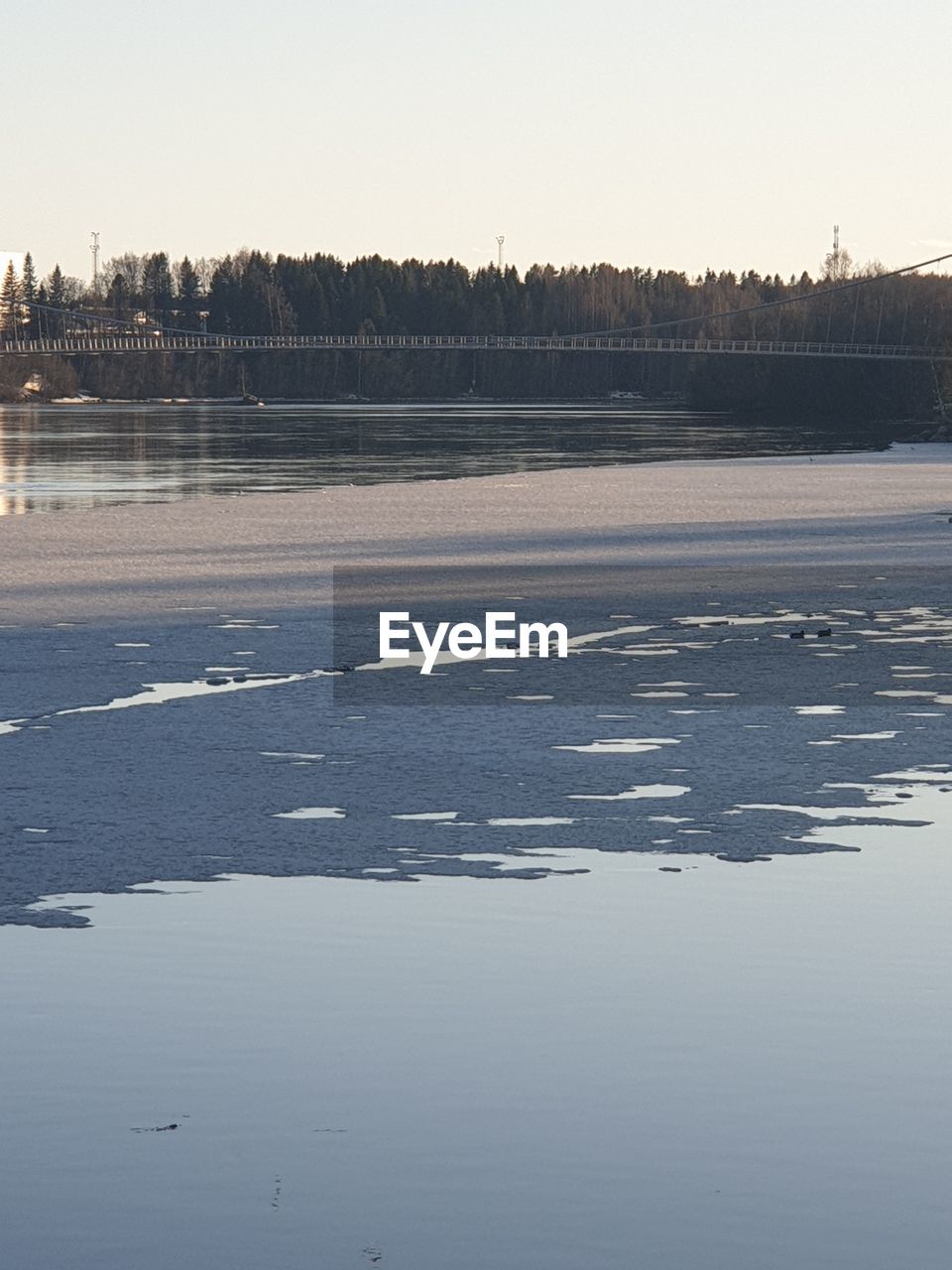 SCENIC VIEW OF FROZEN LAKE AGAINST SKY