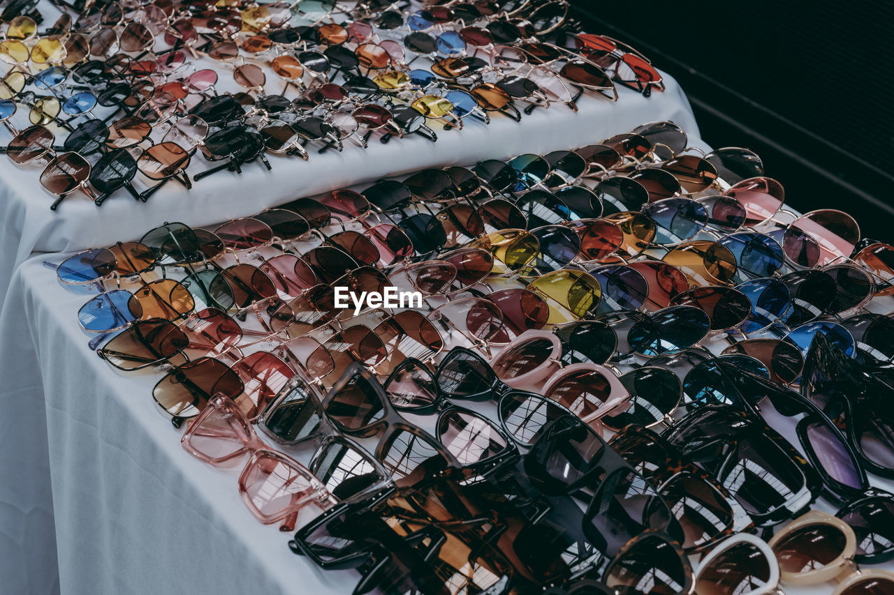 High angle view of colorful sunglasses for sale at market