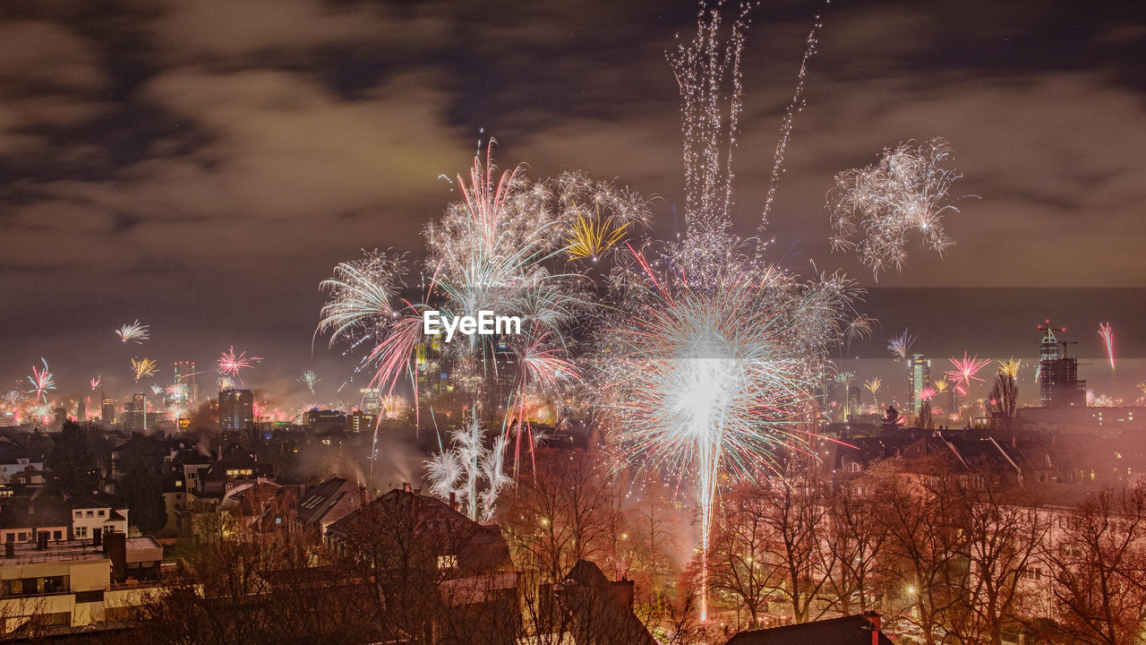 Firework display in city at night