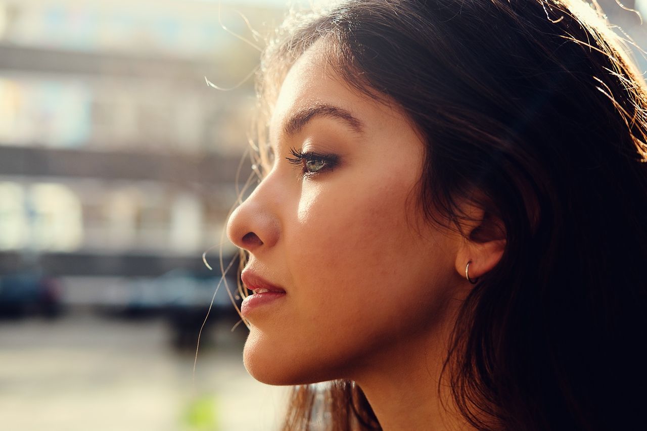 PORTRAIT OF YOUNG WOMAN WITH EYES CLOSED