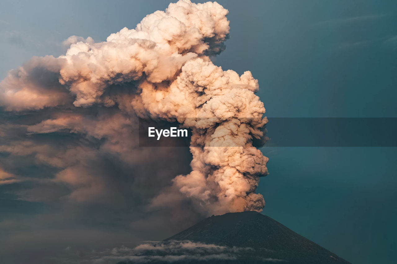 Smoke emitting from volcanic mountain against sky