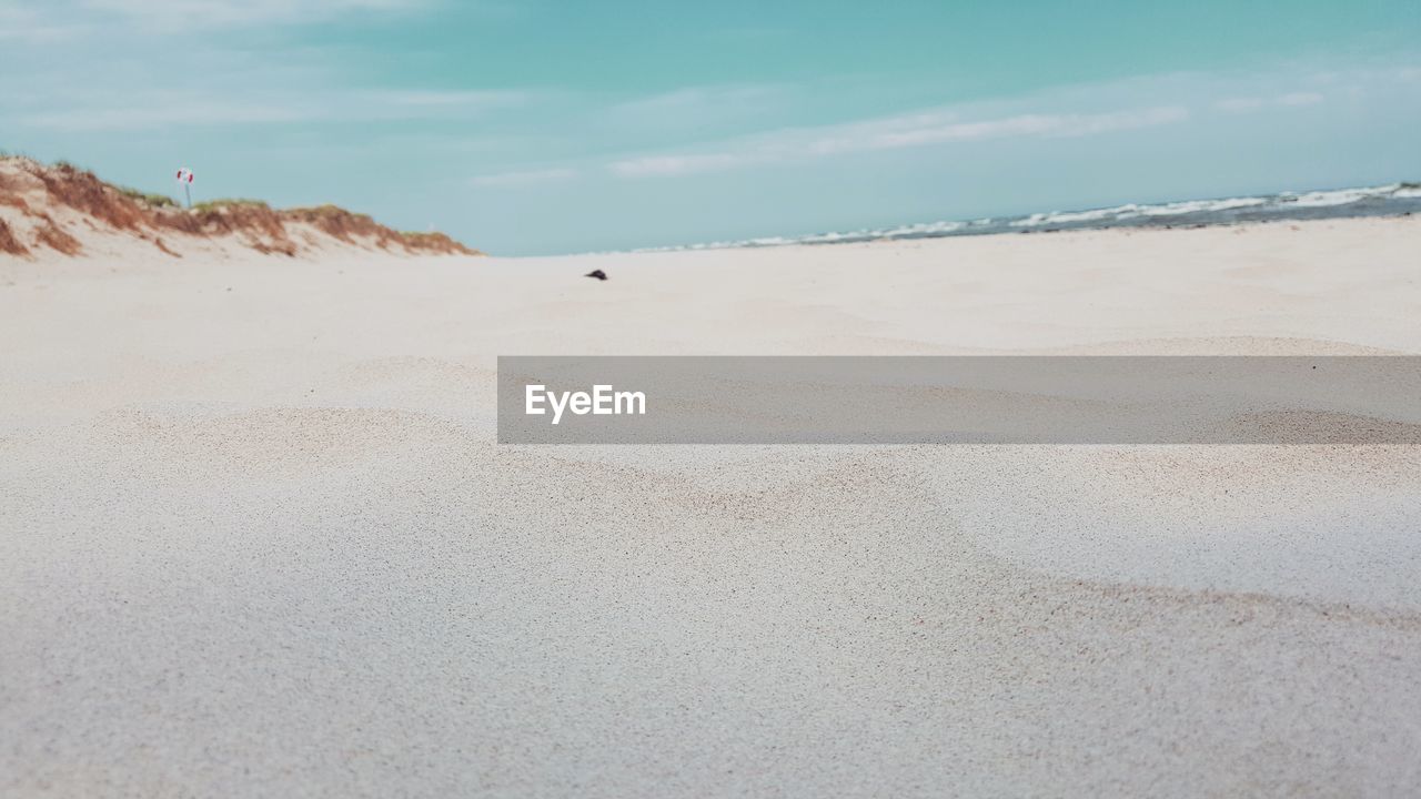 BEACH AGAINST SKY