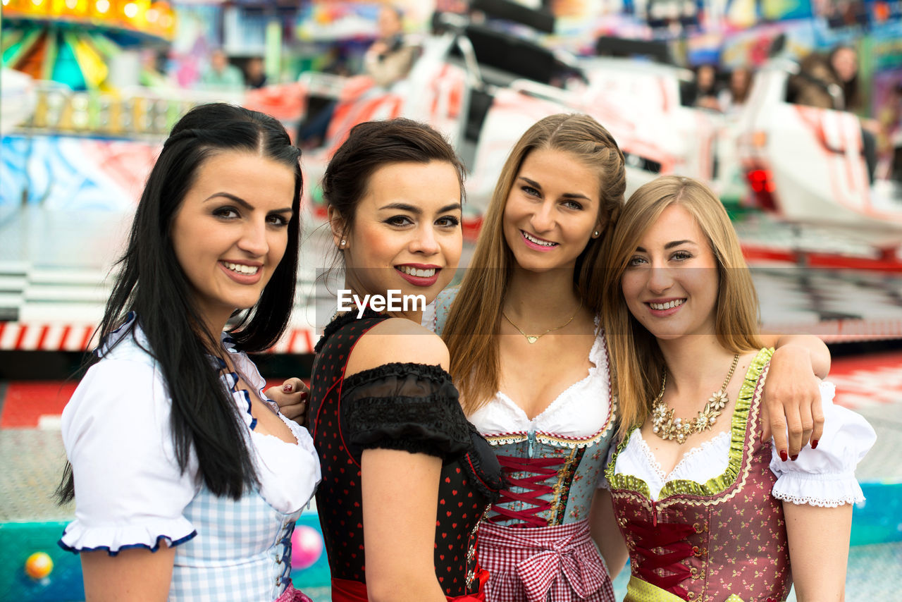 Portrait of happy women wearing dirndl at oktoberfest
