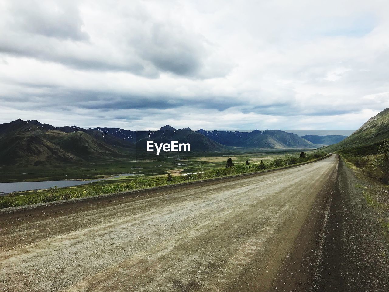 Empty road along countryside landscape
