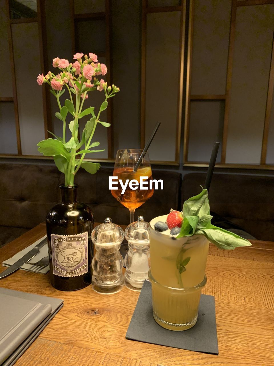 CLOSE-UP OF POTTED PLANT ON TABLE BY GLASS