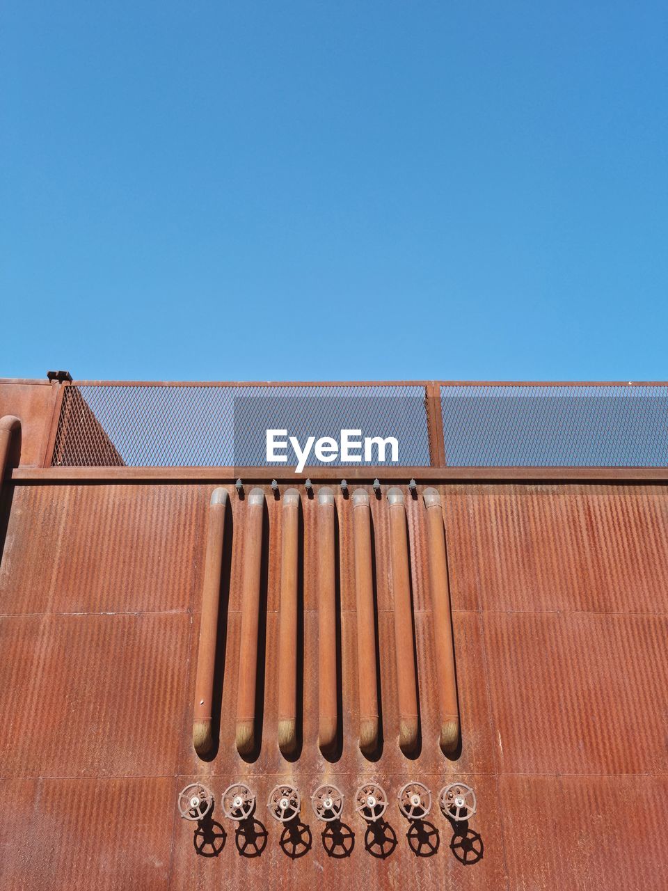 clear sky, blue, sky, roof, copy space, no people, wood, architecture, sunny, day, nature, built structure, brown, metal, sunlight, outdoors, low angle view