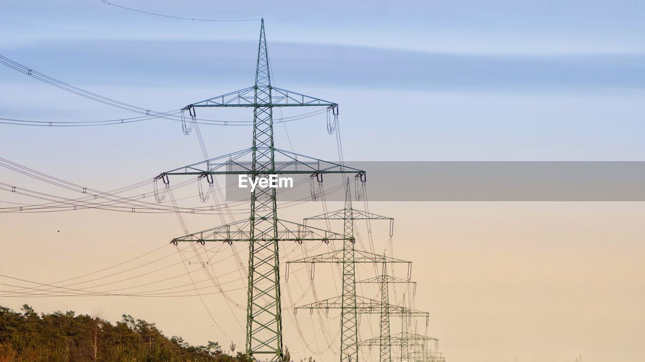 Low angle view of electricity pylon against sky