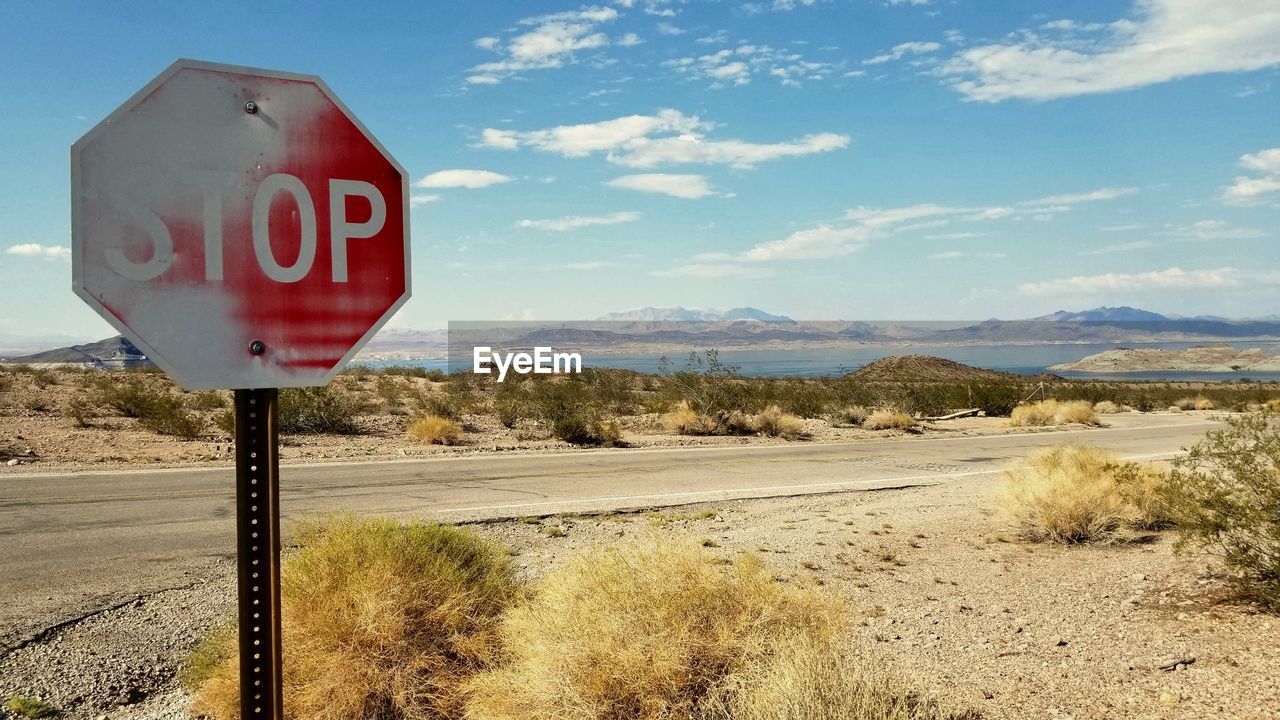 ROAD SIGN AGAINST SKY