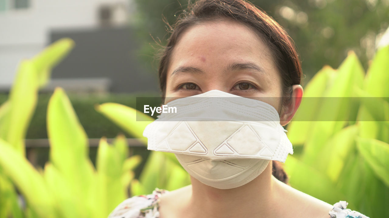 Asian woman wearing mask looking ill cough corona a allergy symptom