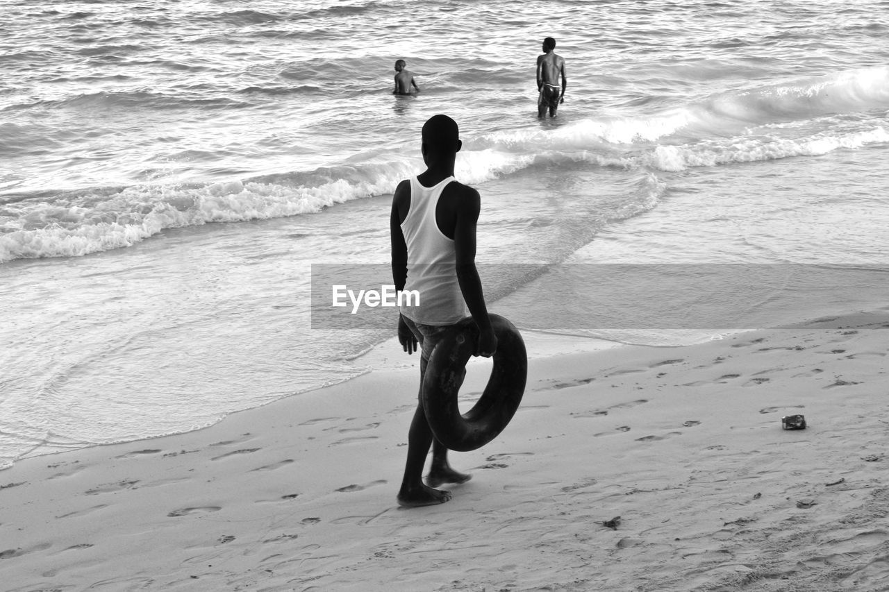 PEOPLE WALKING ON BEACH