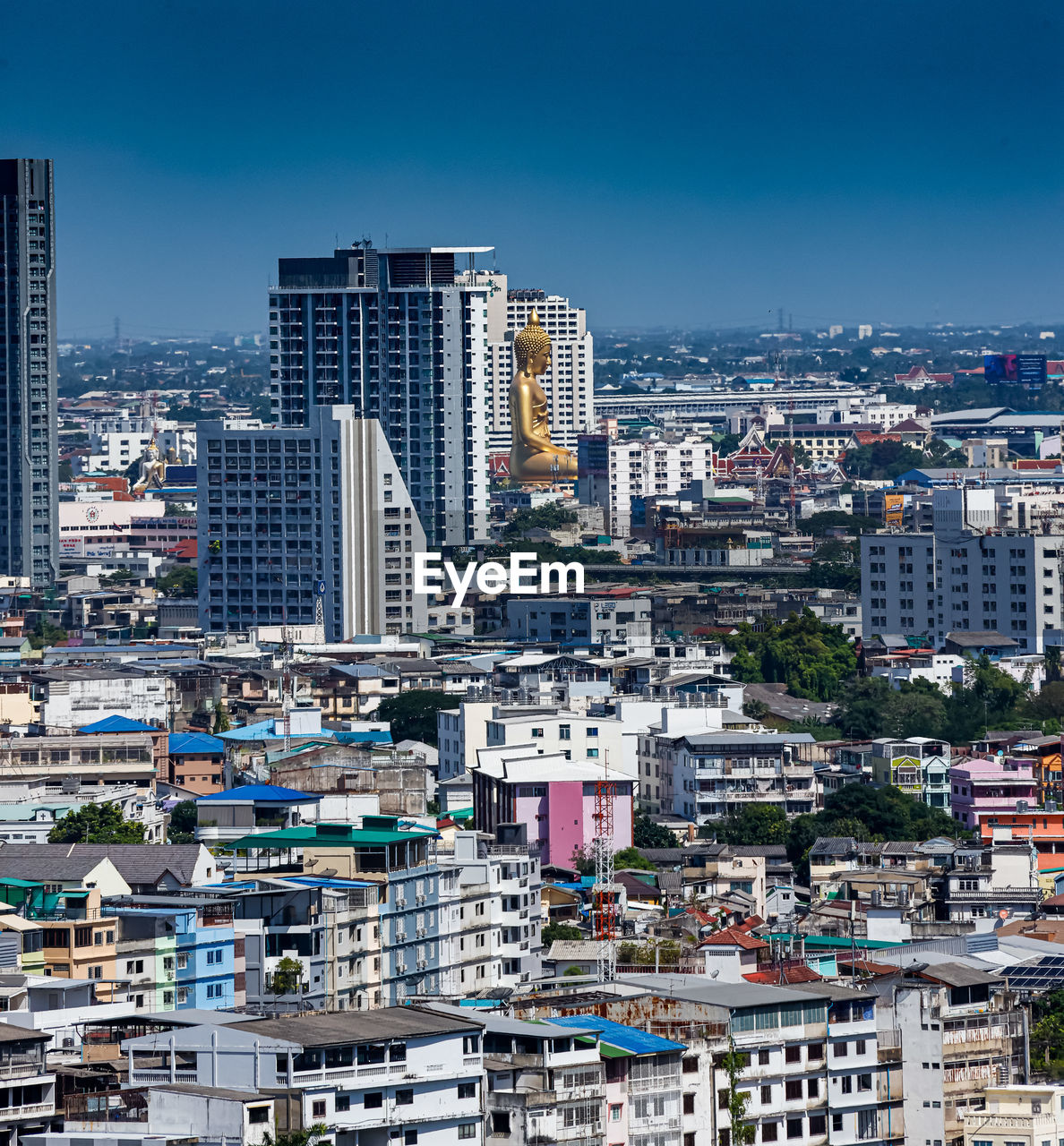 Modern buildings in city against clear sky with thai gold 90m buddha statue newly opened in bangkok