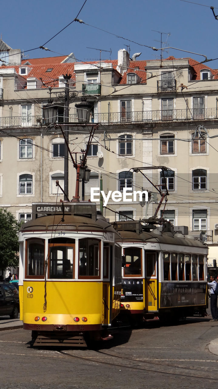 Cable cars against building in city