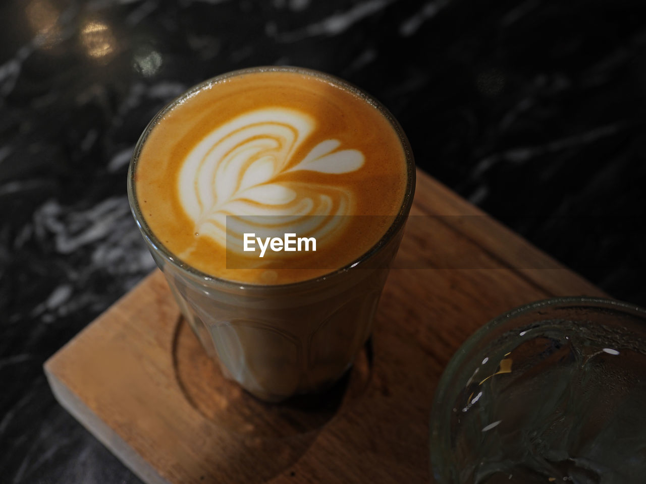 Closeup of cappuccino coffee cup with beautiful heart detail of milk foam. selected focus.