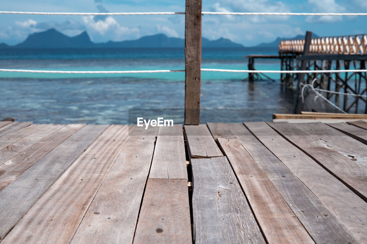 Wooden pier over sea against sky