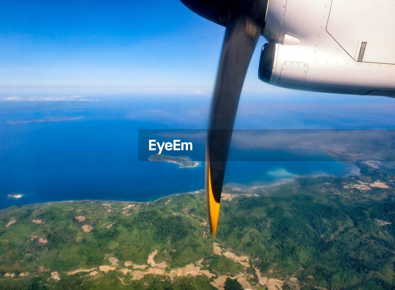 CLOSE-UP OF AIRPLANE WING OVER SEA