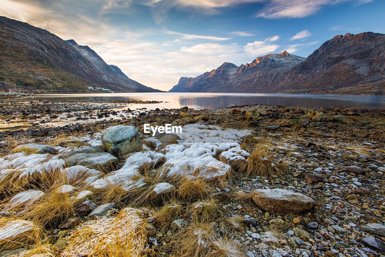 Scenic view of lake and mountains against sky