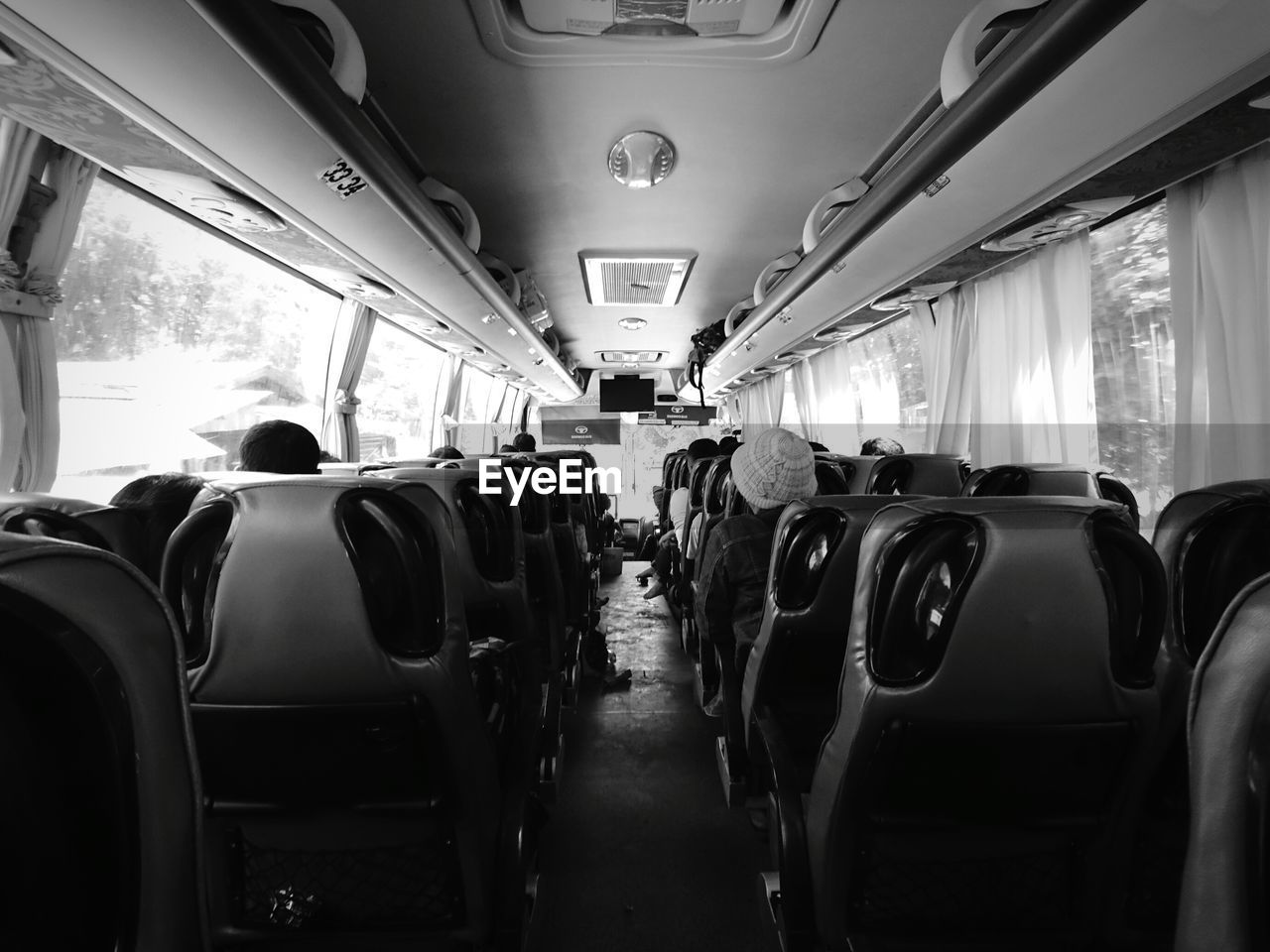 REAR VIEW OF PEOPLE WALKING IN TRAIN