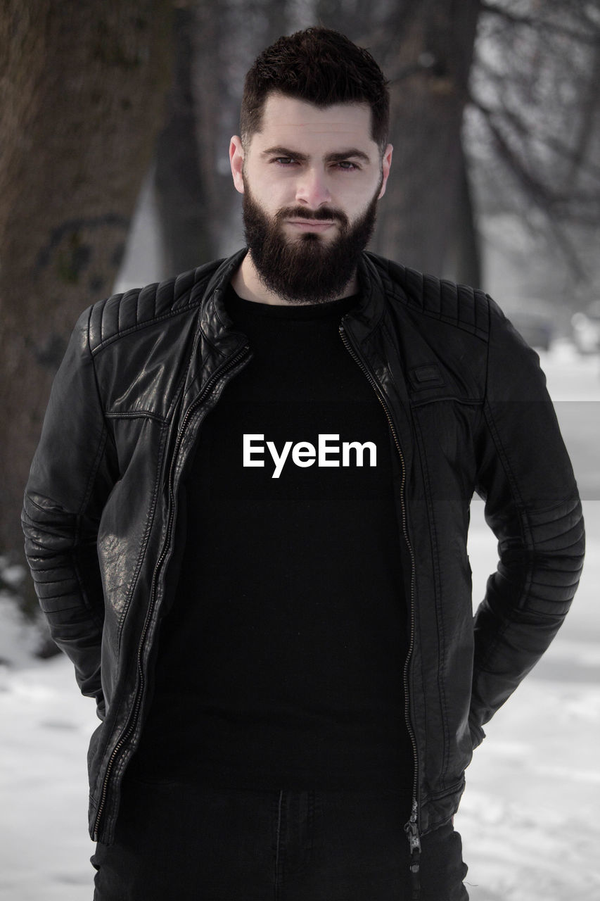 Portrait of bearded man standing outdoors during winter