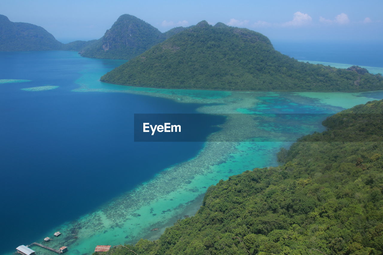 Aerial view of sea and mountains against sky