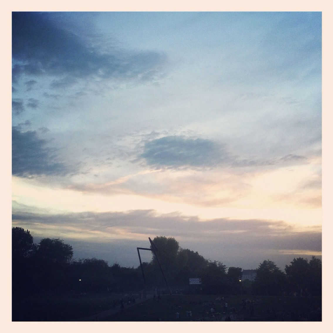 View of park against cloudy sky at sunset