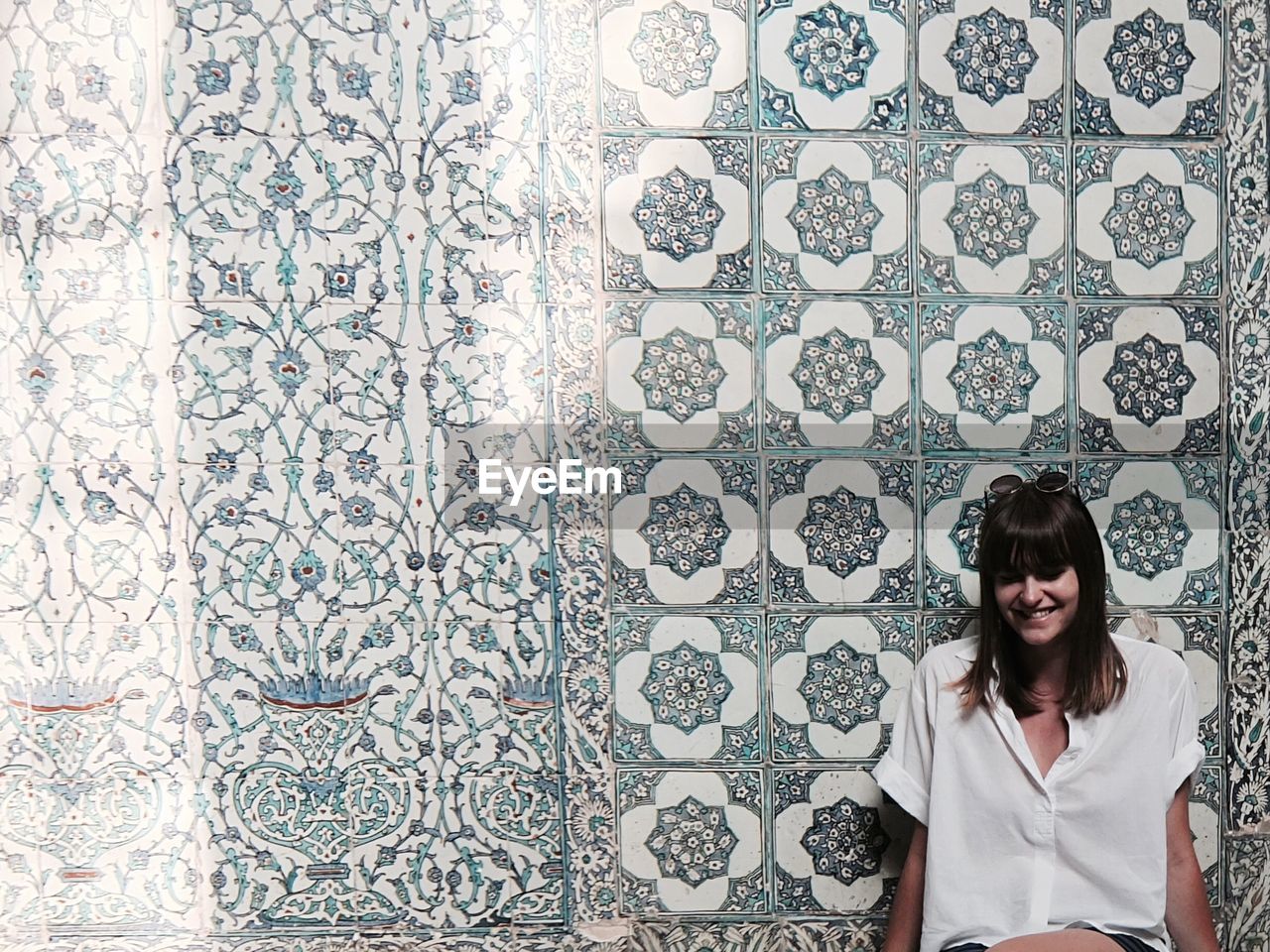 Happy woman against mosaic wall at topkapi palace