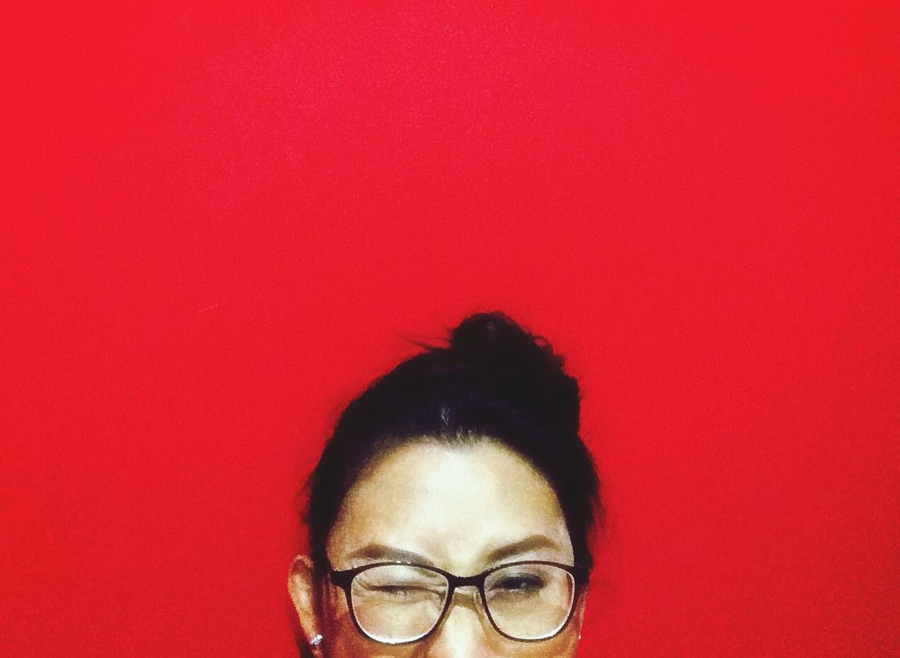 Woman against red wall