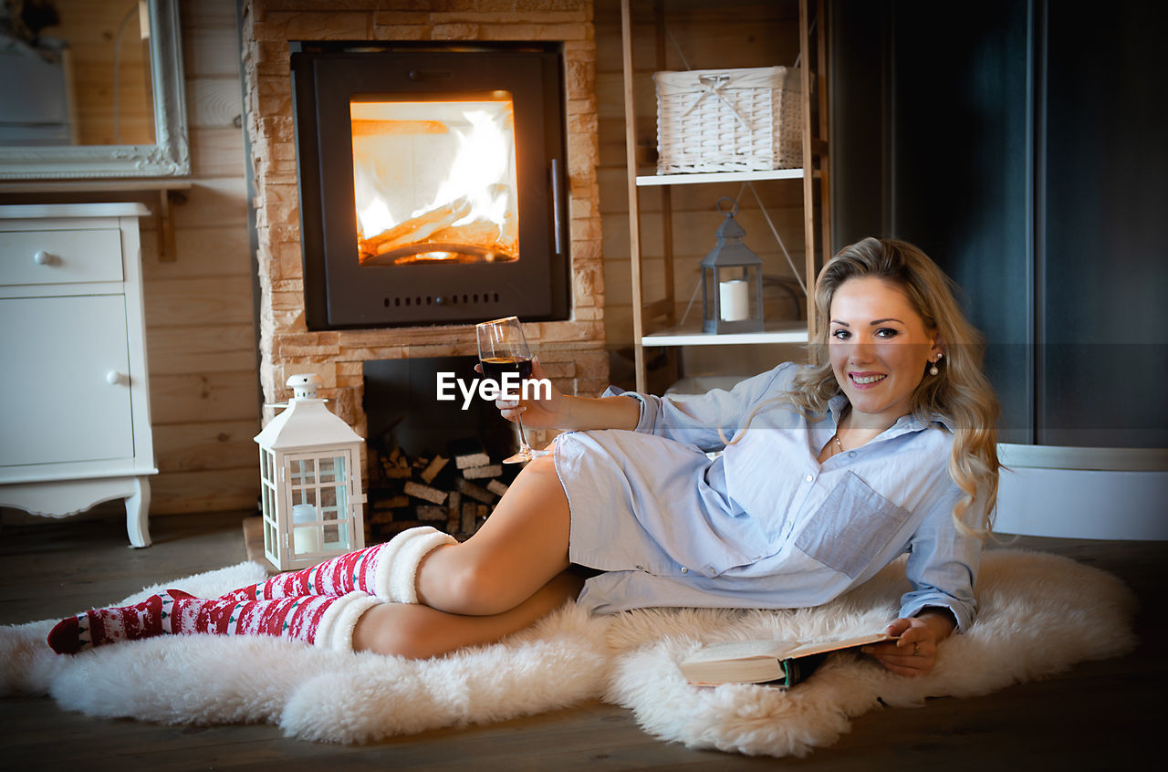 YOUNG WOMAN SITTING AT HOME