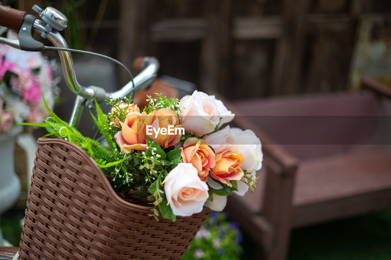Close up of beautiful flowers in basket of bicycle
