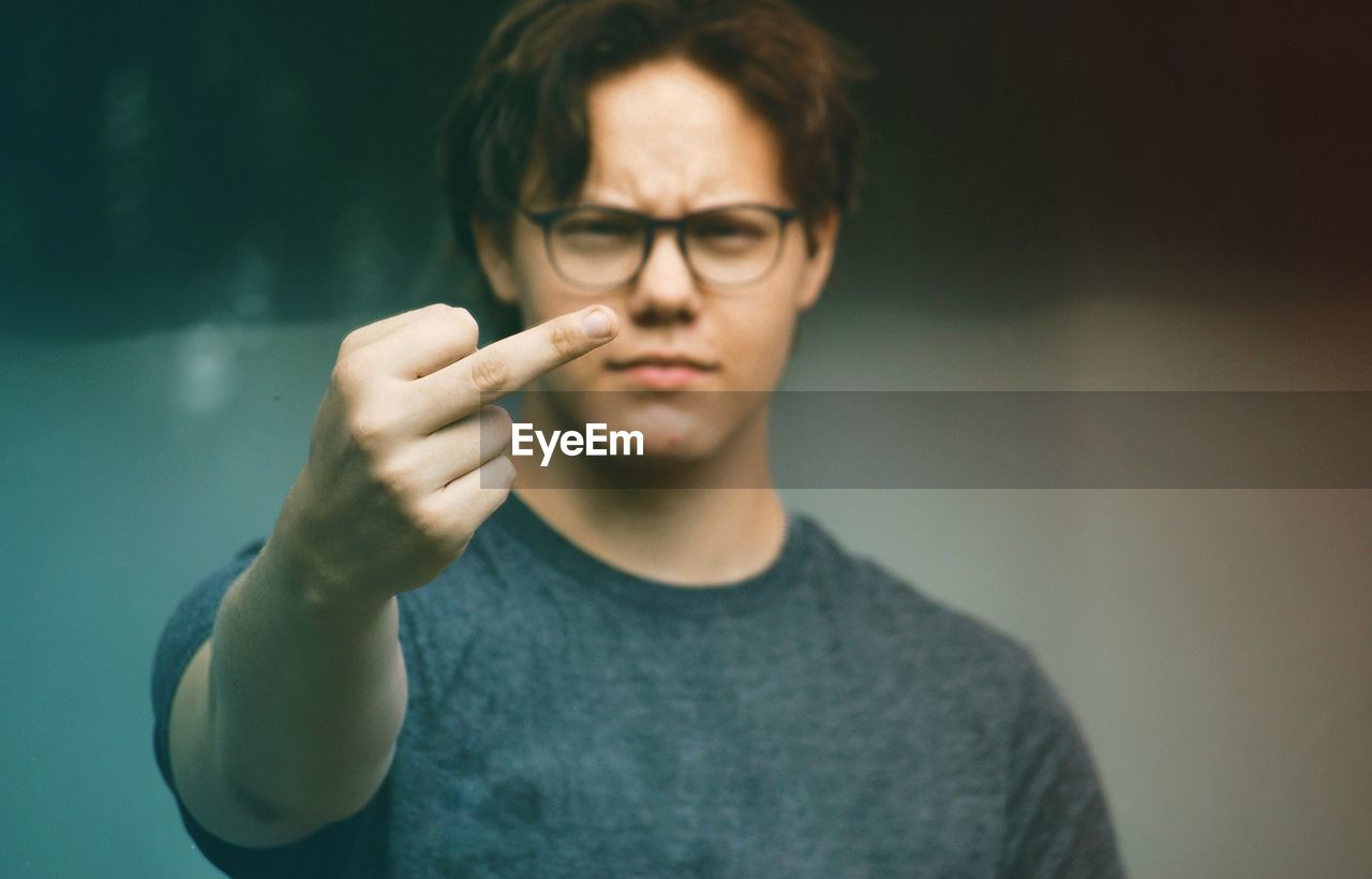 PORTRAIT OF MAN HOLDING CIGARETTE