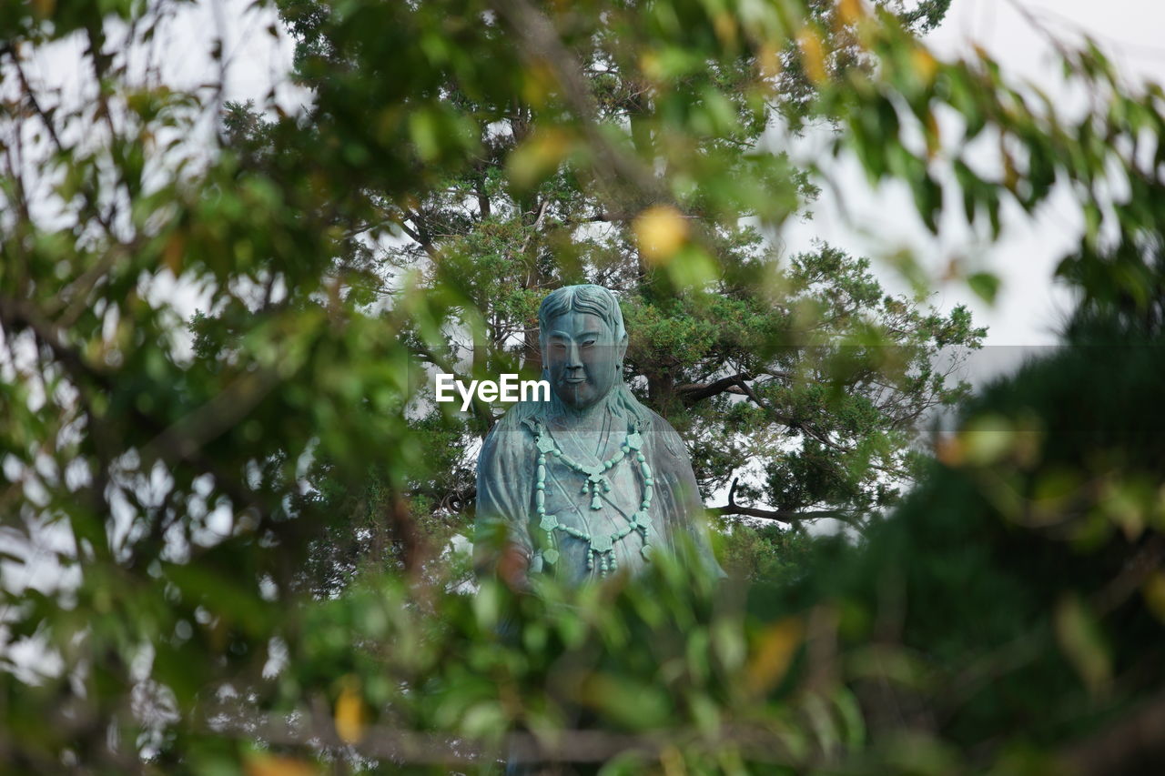 Statue seen through trees