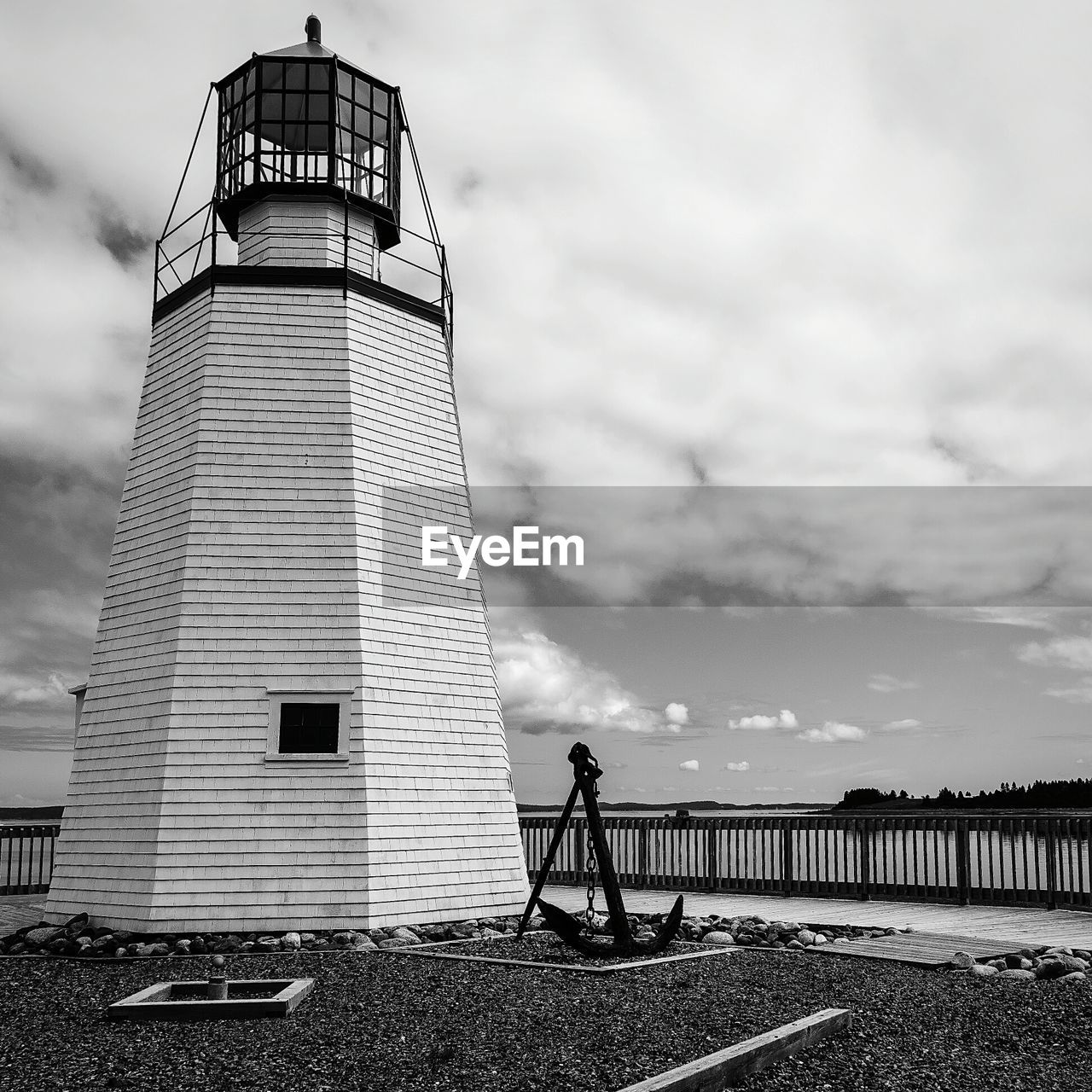 Low angle view of lighthouse against cloudy sky