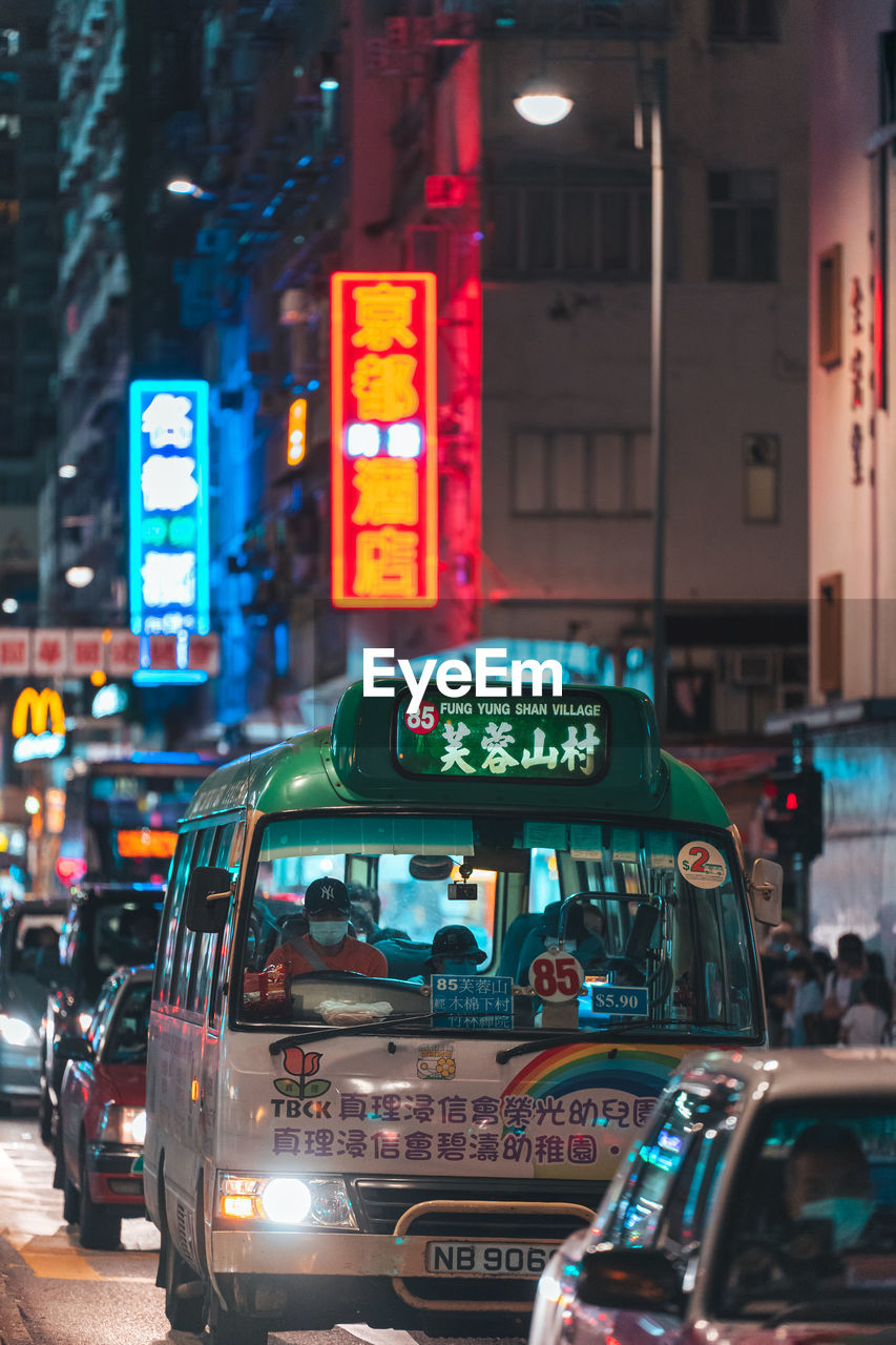 Close up to the minibus with neon lights background.