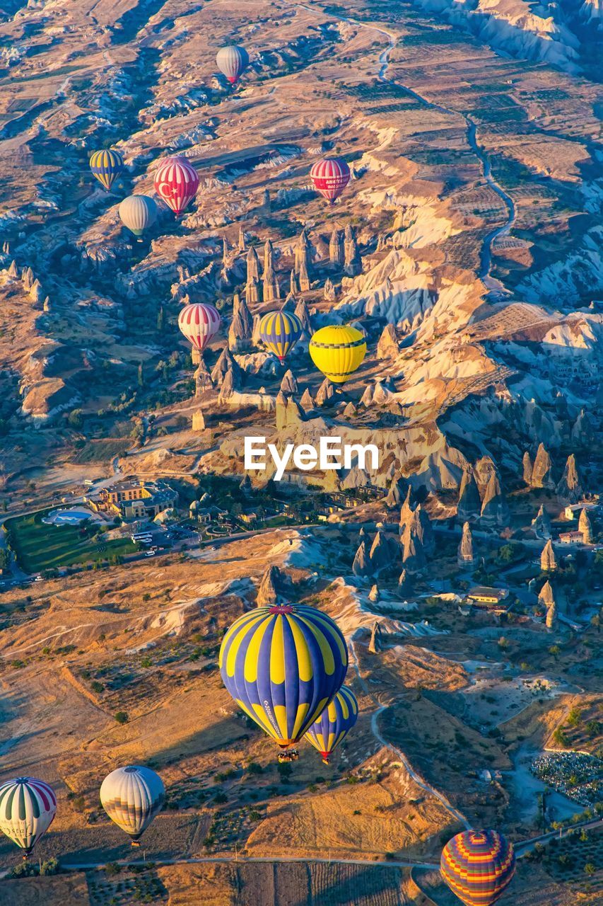 High angle view of hot air balloons flying above cappadocia