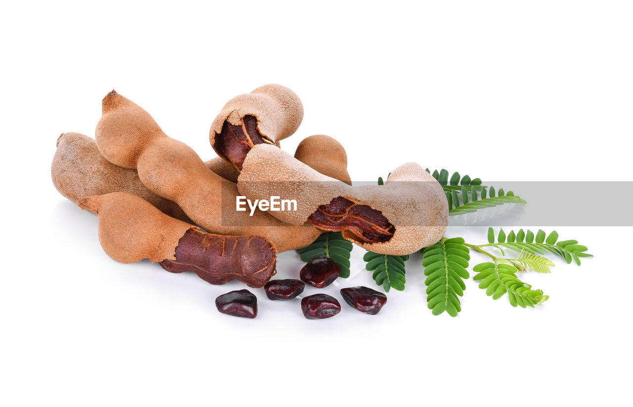 Close-up of tamarind against white background