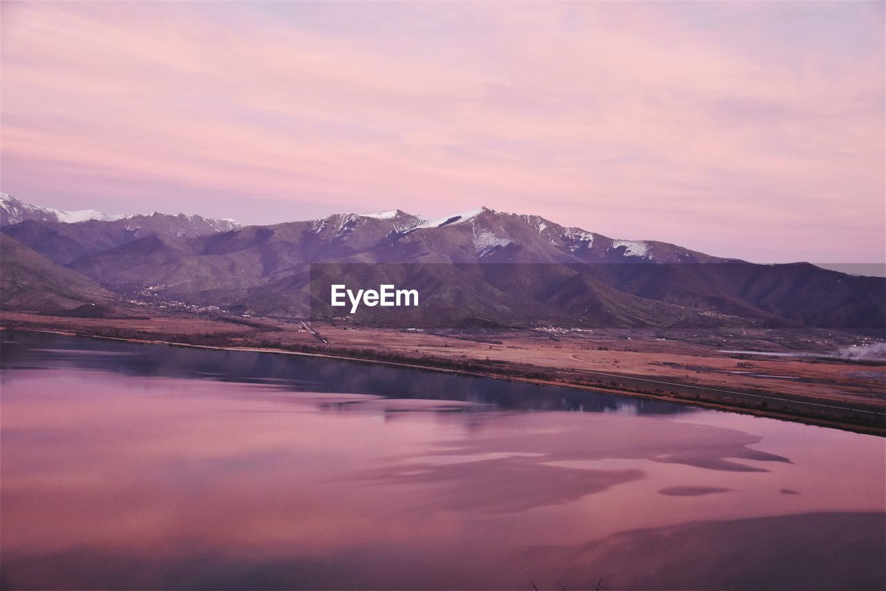 Scenic view of lake against romantic sky at sunset