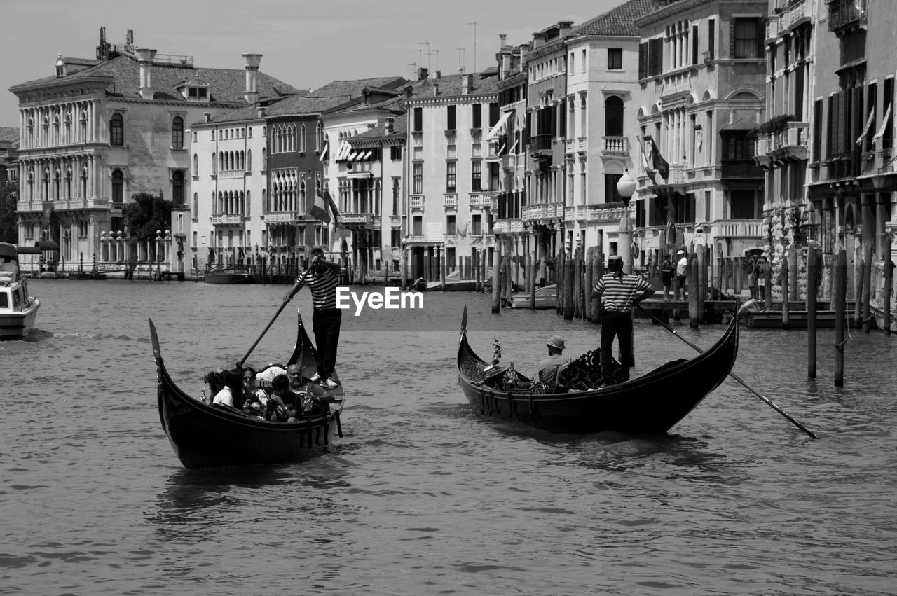 PEOPLE IN BOAT ON WATER