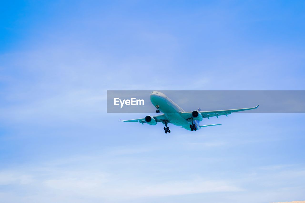 Low angle view of airplane flying in sky