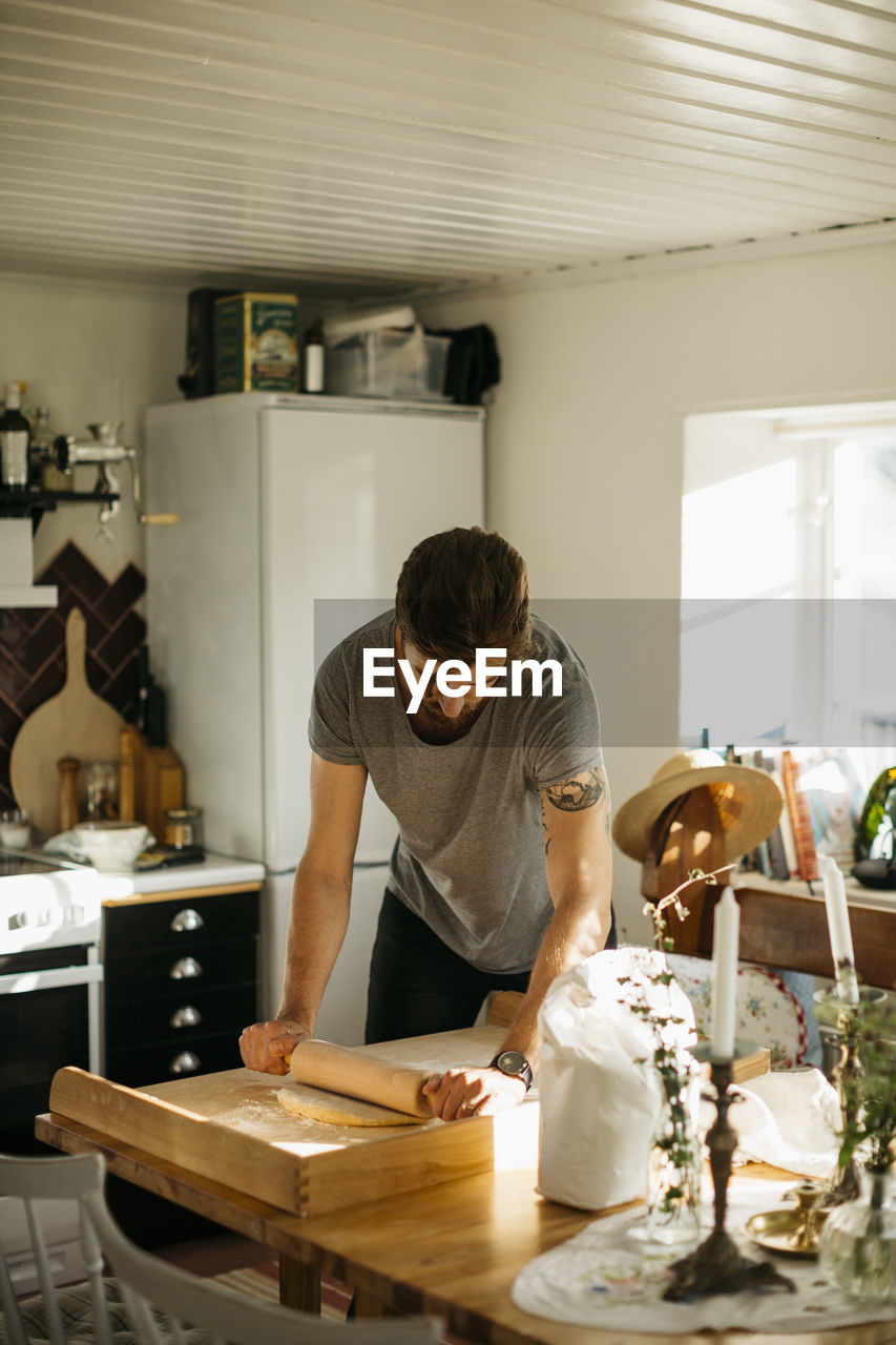 Man rolling dough