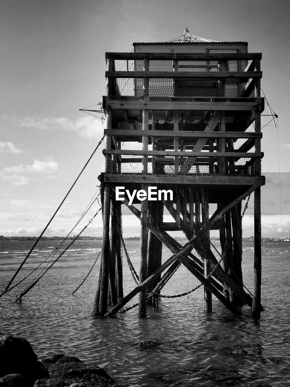 water, black and white, sea, monochrome photography, monochrome, sky, architecture, nature, built structure, cloud, beach, no people, black, wood, day, tranquility, land, outdoors, scenics - nature, beauty in nature, pier, reflection, tranquil scene, white, horizon over water, hut, tower, transportation
