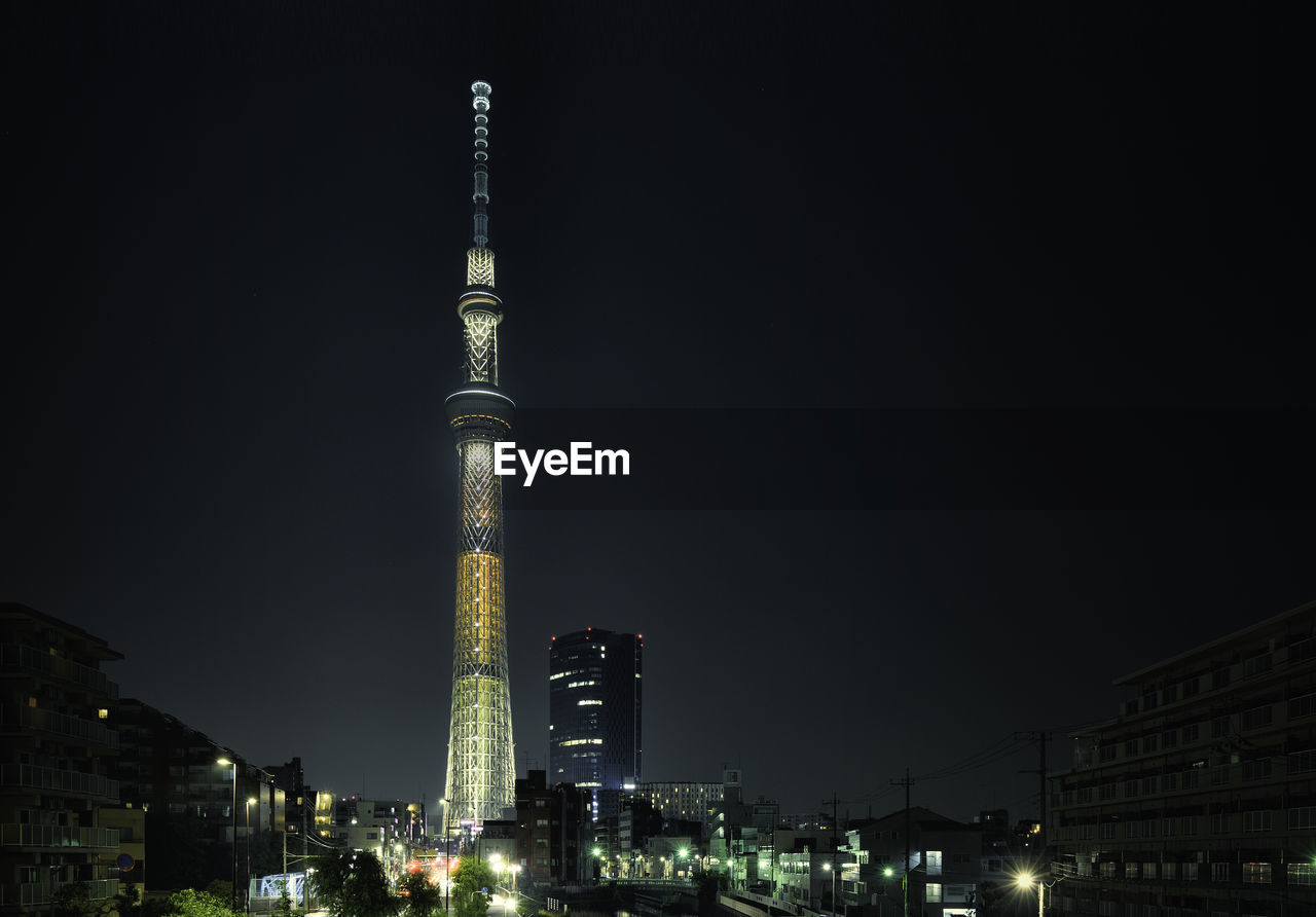 ILLUMINATED SKYSCRAPERS IN CITY