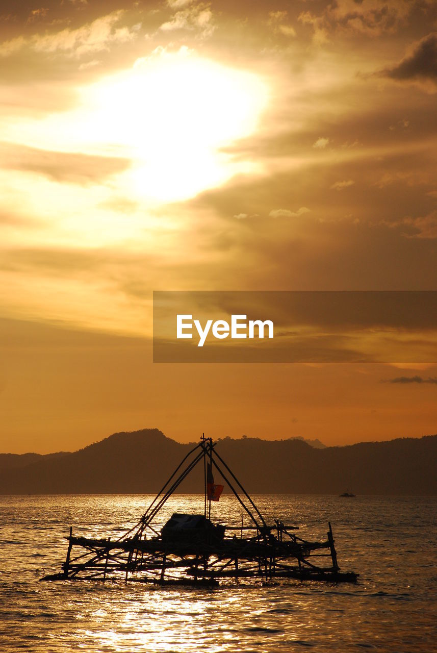 SILHOUETTE BOAT IN SEA AGAINST SKY DURING SUNSET