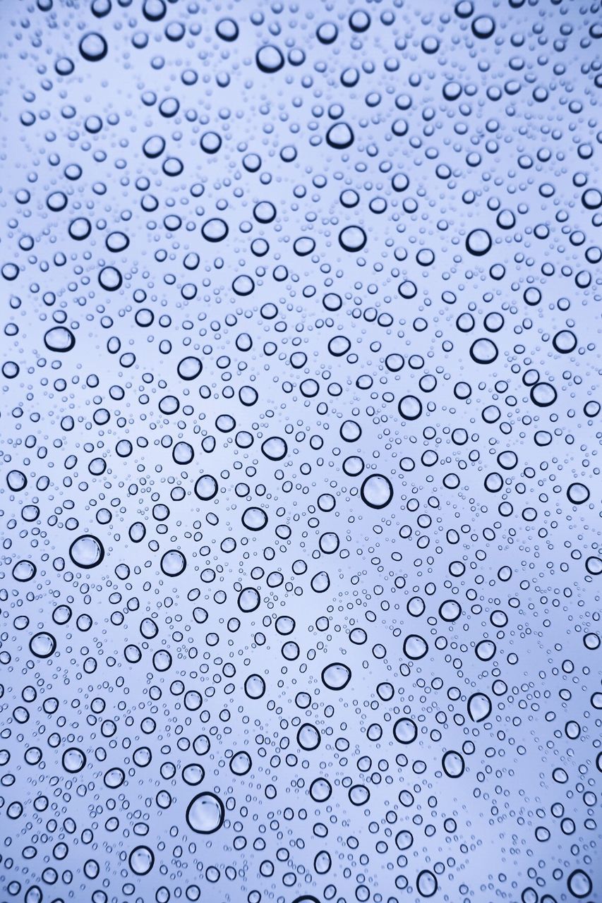 FULL FRAME SHOT OF WATER DROPS ON BLUE BACKGROUND