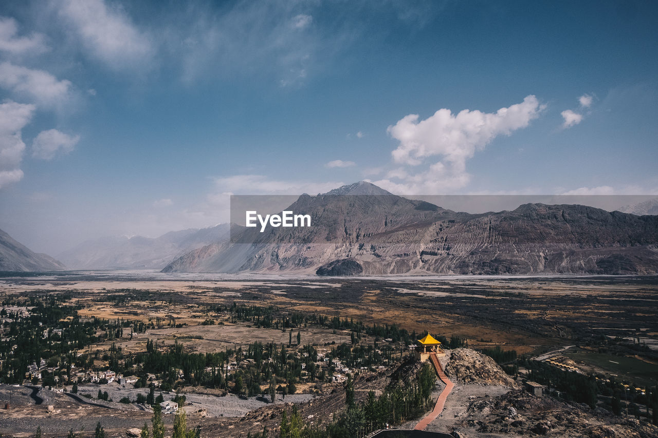 Landscape against mountains