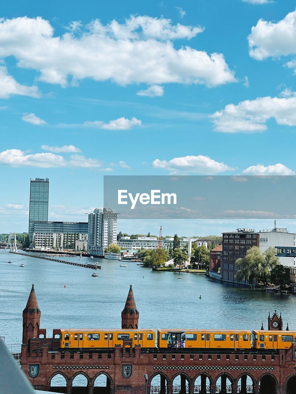 BRIDGE OVER RIVER AGAINST BUILDINGS IN CITY