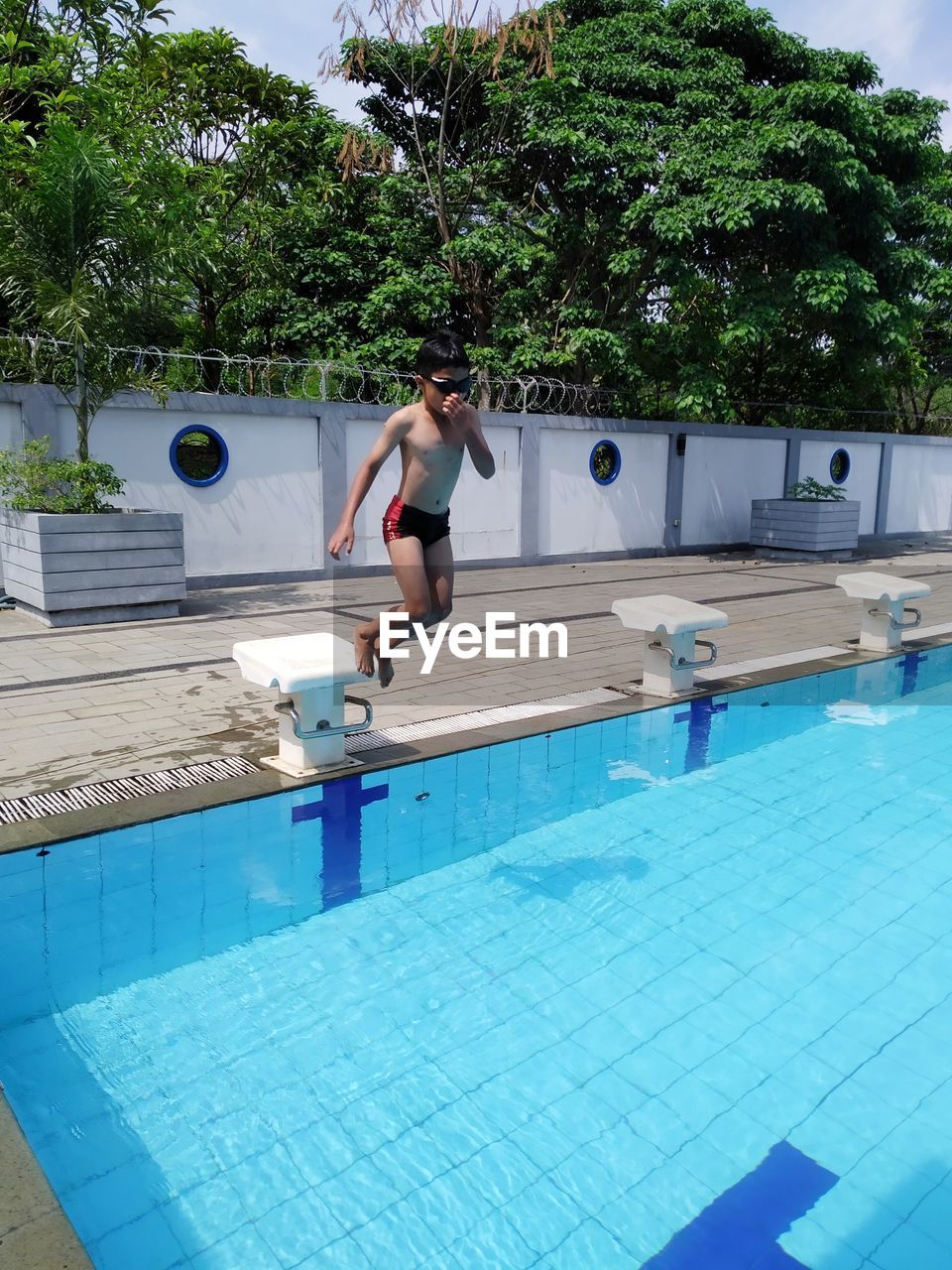 Man jumping in swimming pool